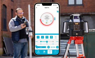 Contractor using Plott PRL900HT-R rotary laser with smartphone app control on job site