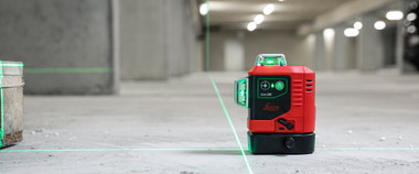Leica Lino L6G green multi-line laser projecting 360 degree green lines across a large bright warehouse floor
