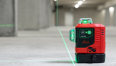 Leica Lino L6G green multi-line laser on a concrete floor with three crisp green 360 degree laser lines