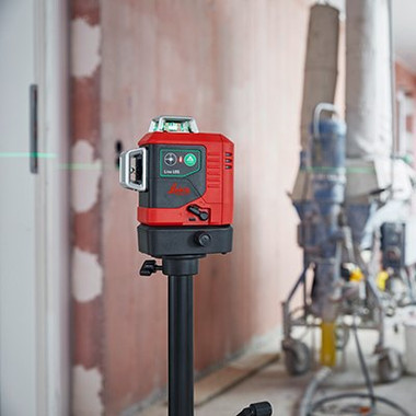 Leica Lino L6G on a tripod transferring a benchmark height across a room under construction