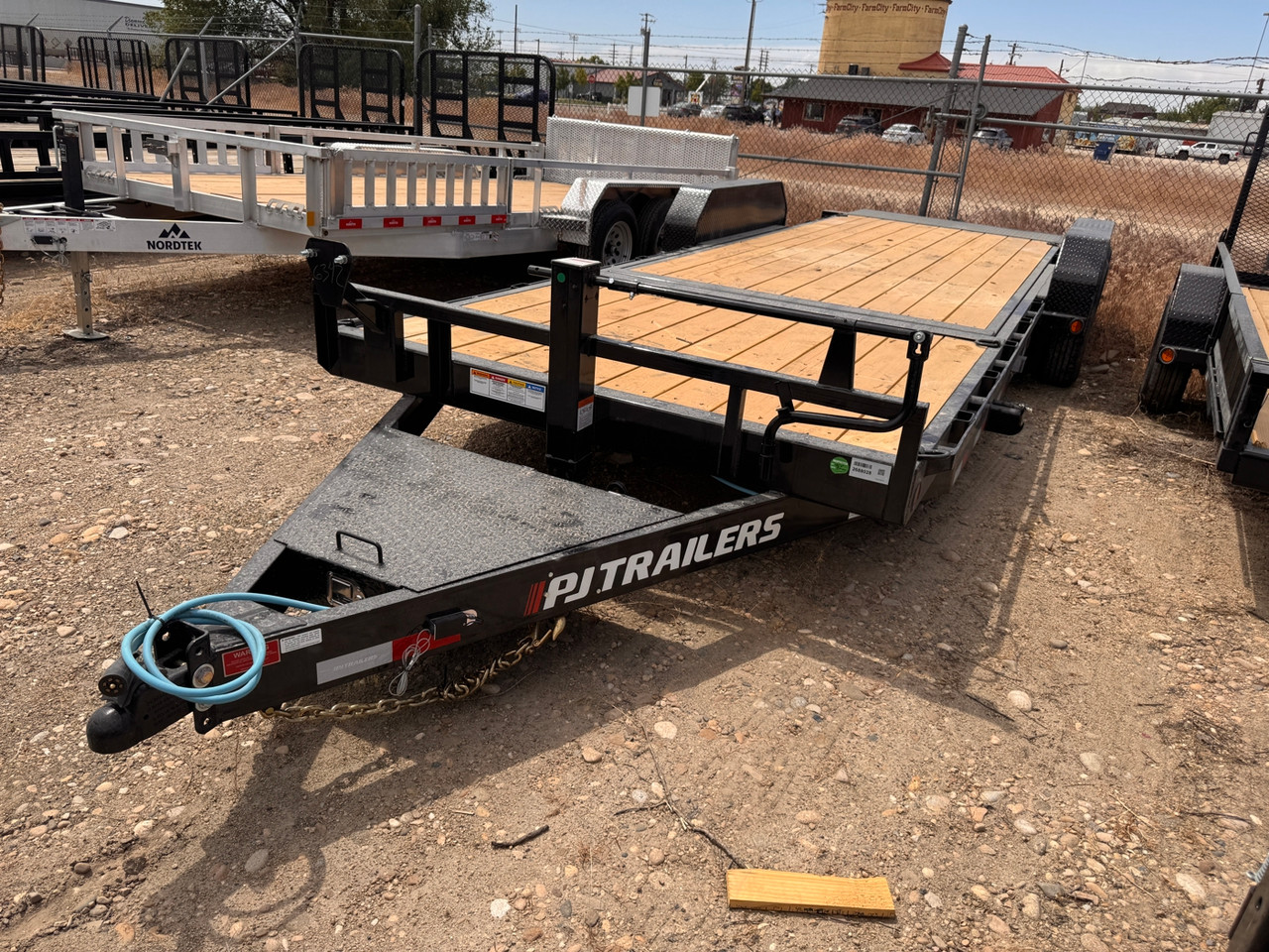 P.J. Trailers 2027 T6 22' Equipment Tilt Trailer | Tandem Axle 14K, Lid Over Tongue, Fork Holders