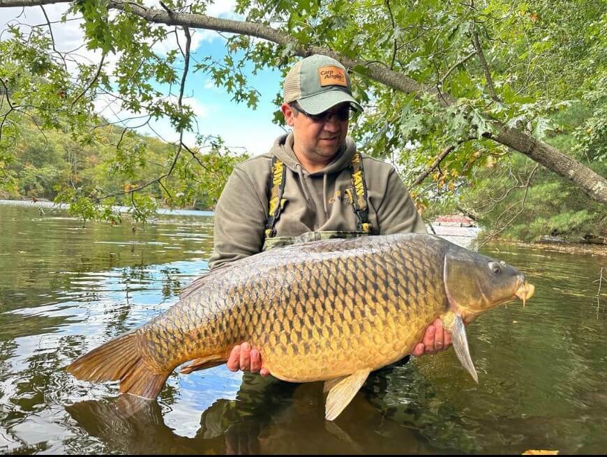 The founder of Carp Angler holding a massive carp