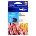 Brother LC73 Cyan Ink Cartridge, genuine Brother product packaging with colorful pencils in the background.