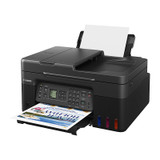 Canon G4670 MegaTank Printer, black, with paper tray extended and colorful print emerging.