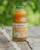 A bottle of Sunrise Blend on a table outdoors