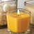 Small square orange candle in square candle jar