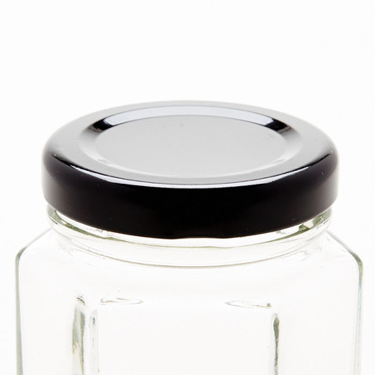 black canning lid on hexagon jar