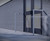 Silver L-shaped door barrier with integrated buffer, designed to protect doors from wind damage and frequent use, featuring a hot-dip nylon-coated 38mm mild steel tube and 'cane detector' technology for the visually impaired.