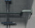 Left-hand corner grab rail in grey, firmly installed on tiled walls, providing reliable support for enhanced safety and accessibility in showers and wash rooms.