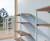 BOYCO 4-tier slatted wall and floor fixed shelving system in light grey, measuring 1000 mm long by 400 mm deep, with four open shelves supported by vertical slats for versatile storage.