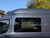 Ford Transit awning window, premium van window, VWD awning window, Transit van ventilation, van window with shade, retractable bug screen, solar privacy glass, secure van window, high-roof Transit window, driver side awning window, urethane bonded window, van conversion window, privacy van window, minimal frame van window, Ford Transit window upgrade, easy install van window, weatherproof van window, UV protection van window, bug screen van window, insulated van window.-install-1