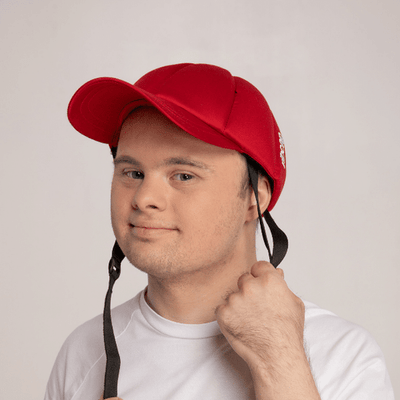 Picture of a boy wearing a red baseball cap with a chin strap Picture of a boy wearing a red baseball cap with a chin strap