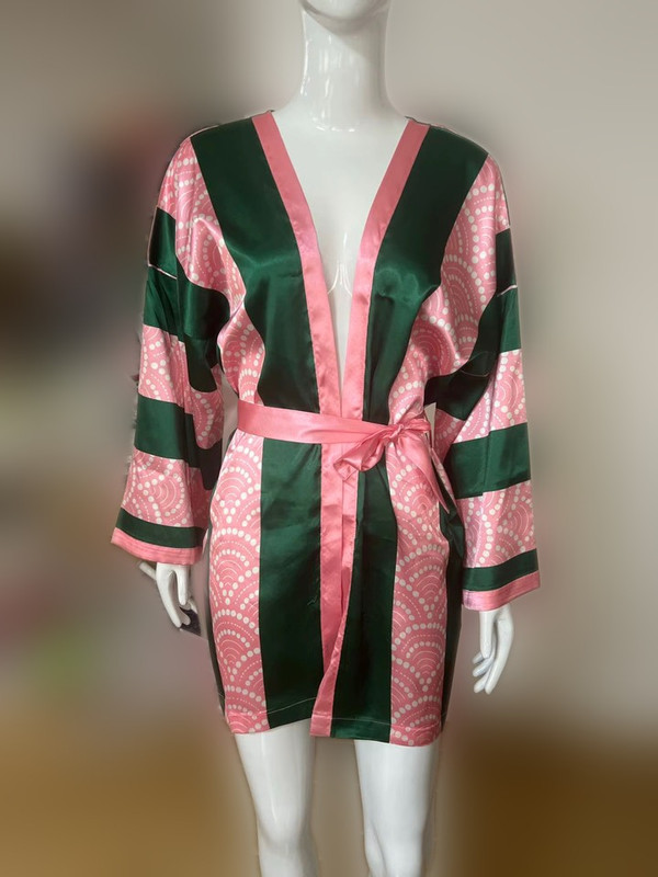 Pearl Wave Stripe Kimono in pink and green on a mannequin, background blurred