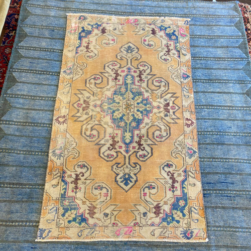 4’6 x 7’8 vintage tribal Turkish zero-pile rug with light orange, blue and pink accent colors