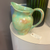 9" large water pitcher by Aletha Soule, vintage c. 1992. Green + brown underglaze.