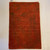 20 inches X 3‘ 0“ rusty red and brown floral pattern handknotted and tibetan style rug