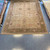 9’11” x 12’10” light brown, olive green and pink traditional oushak style handmade wool carpet from India