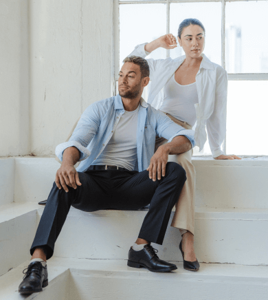 Man wearing white Thompson Tee under an unbuttoned dress shirt.