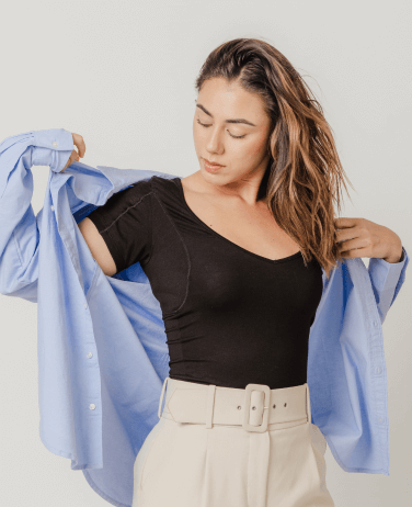 Woman wearing black Thompson Tee under a blue dress shirt