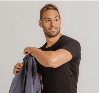 Man posing in a black Thompson Tee