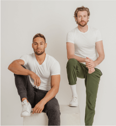 Two men wearing v neck and crewneck white Thompson Tees
