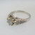 18k White Gold Approx 1.07ct TW Round Brilliant Cut Diamond with Accent Diamonds Surrounding Mount. Size 6 ¼