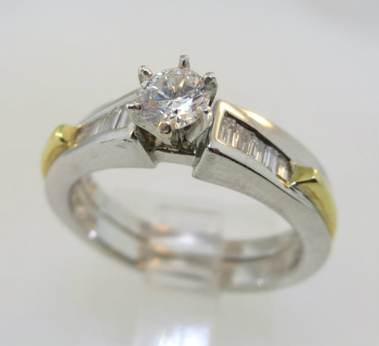 Platinum and 18k Yellow Gold Approx. .25ct TW Round Brilliant Cut Diamond Ring with Baguette Accents. Size 7