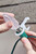 Smart Clip on Roofline with Hands Attaching Bulb into Socket