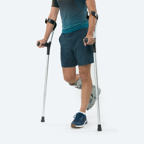 Man using ProCare Universal Forearm Crutches with an Airselect Moon Boot on