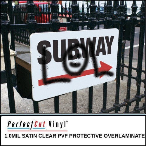 PerfectCut Vinyl 1.0mil satin clear PVF protective overlaminate, shown protecting a "Subway" directional sign with graffiti on it, mounted on a wrought iron fence, demonstrating the film's graffiti-resistant and easy-clean properties.