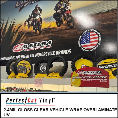 PerfectCut Vinyl 2.4mil gloss clear UV vehicle wrap overlaminate, shown protecting a large printed retail wall graphic and point-of-sale display in a motorsports parts store.