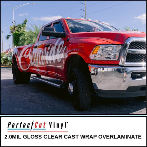 PerfectCut Vinyl 2.0mil gloss clear cast wrap overlaminate, shown protecting a glossy red pickup truck wrap with white script lettering, parked outdoors under a blue sky.