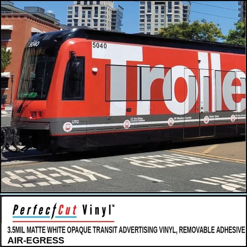 PerfectCut Vinyl 3.5mil matte white opaque transit advertising vinyl with removable air-egress adhesive, shown as a red full-side wrap reading "Trolley" on a light-rail transit car in a downtown setting.