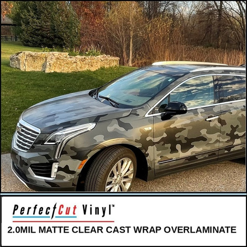 PerfectCut Vinyl 2.0mil matte clear cast wrap overlaminate, shown protecting a gray and black camouflage SUV wrap, parked outdoors on a driveway.