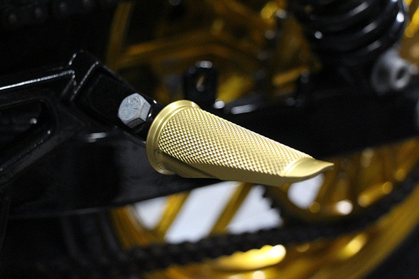 Speed Merchant Gold Anodized peg installed on Harley Dyna