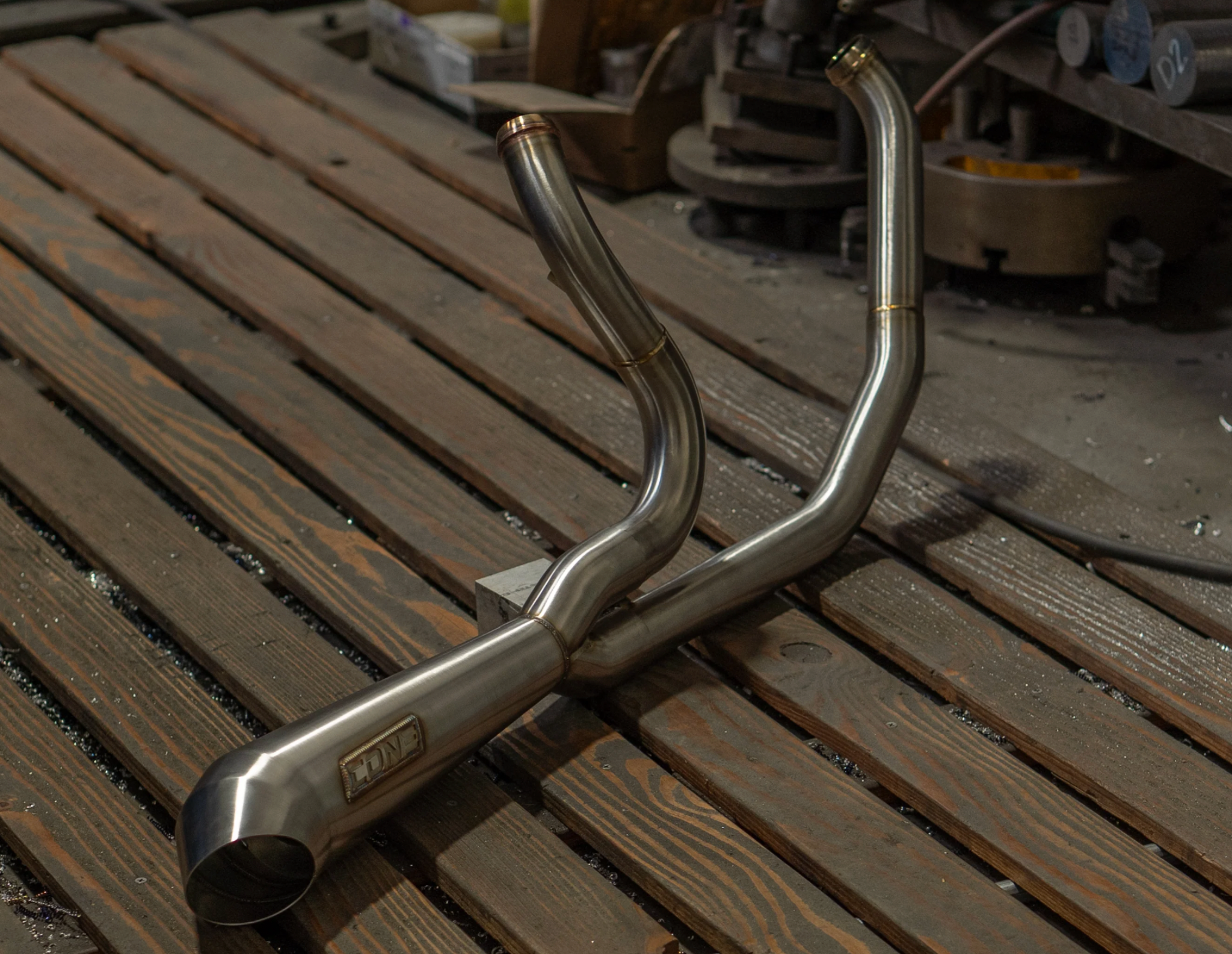 Cone Performance stainless two into one header section on workbench