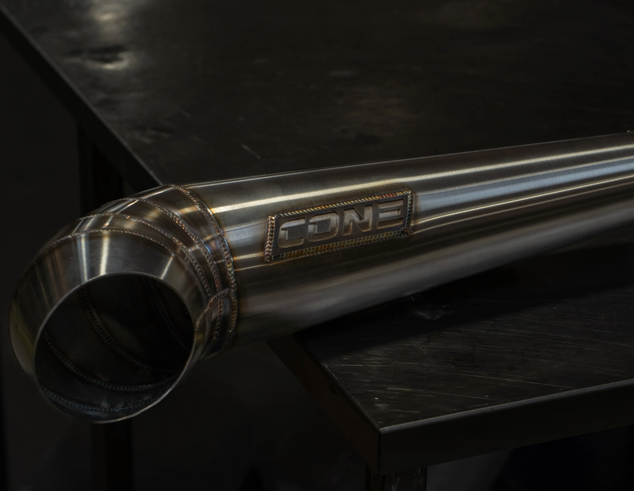 Close up of Cone Performance muffler showing weld detail and Cone badge