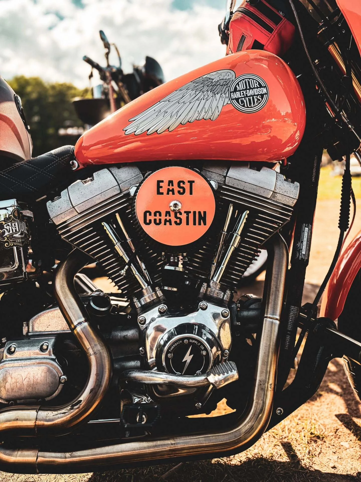 Orange Harley-Davidson tank with an East Coastin cap at the 2026 Deadbeat Retreat