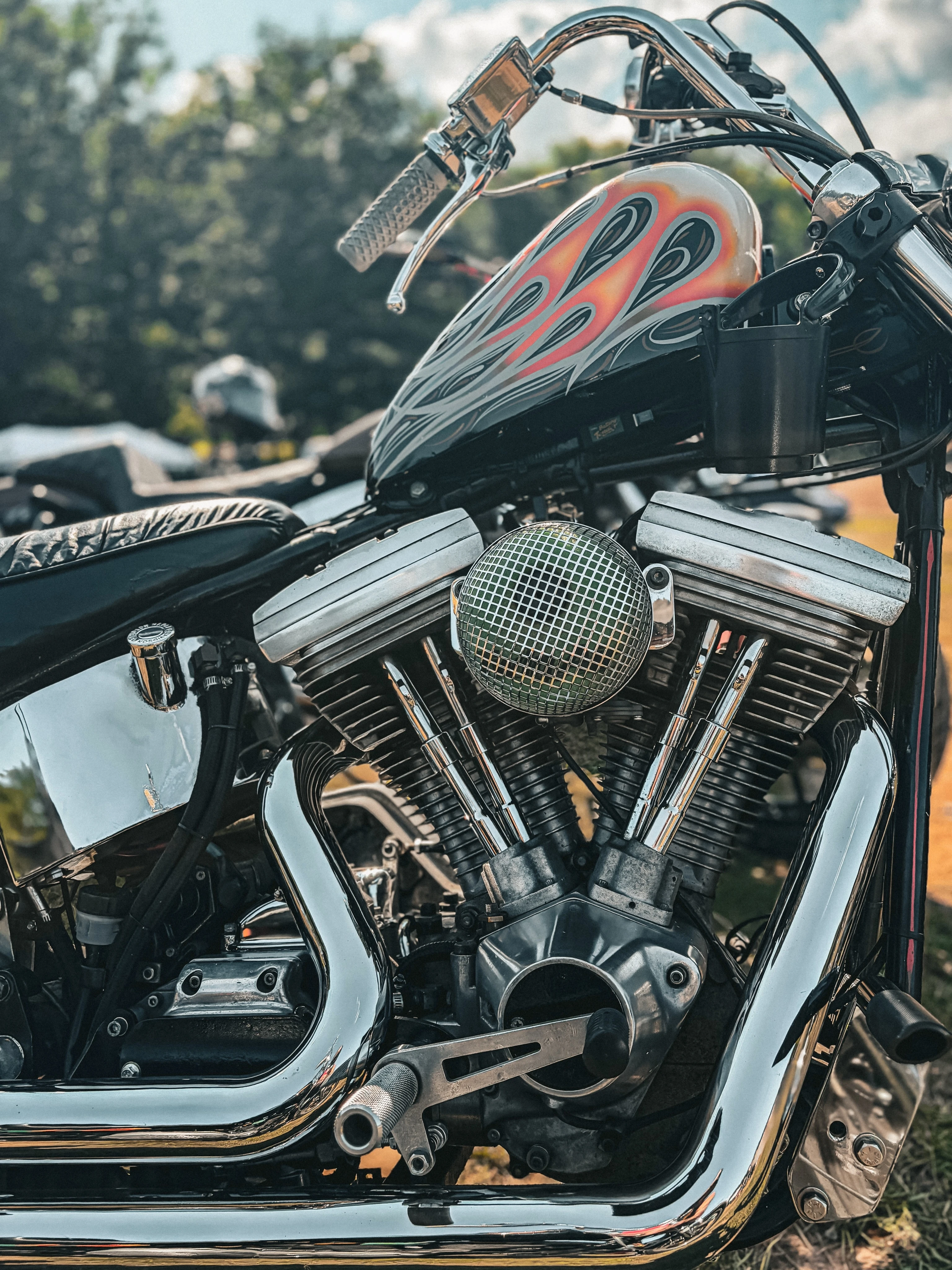 Black tank with orange flames over a V-twin at the 2026 Deadbeat Retreat