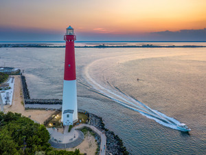 A Boat Passing By The Barnegat Lighthouse