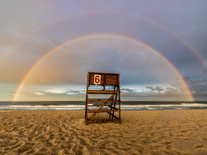 A Double Rainbow Over A Lifeguard Stand On The Beach