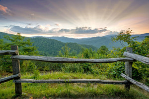 Sun Rays at Sunset Over the Fence Rails