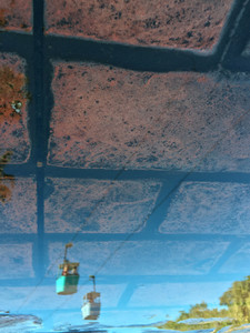 Cable Cars Passing Along Brick Sky