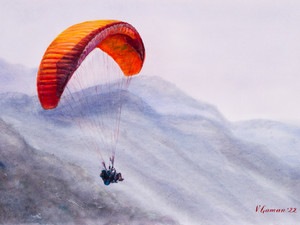 A paraglider in tandem soars over the mountains in a foggy haze.