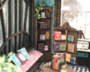 1:48 quarter scale corner shelf with the books and boxes, shown in the Joie de Vivre Bookshop.