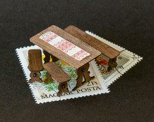 An old-fashioned, European style table and benches kit for 1:48 (quarter) scale dollhouse miniature scenes.