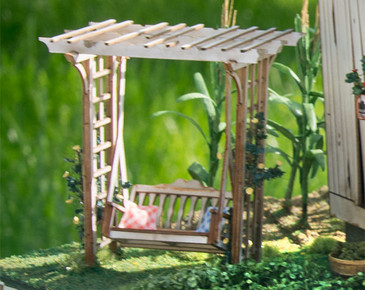 quarter scale arbor with swing, shown weathered next to A Bushel and a Peck kit.