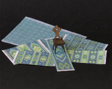 An assortment of blue and green color rugs / carpets in 1:48 (quarter) scale for dollhouse miniature scenes.