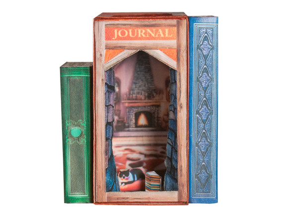 A miniature book nook kit with a cabin interior.