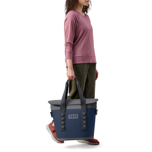 https://cdn11.bigcommerce.com/s-zut1msomd6/images/stencil/500x659/products/39705/239939/yeti-hopper-m15-soft-cooler-18060131261-navy-model-tote__21996.1696351676.jpg?c=1